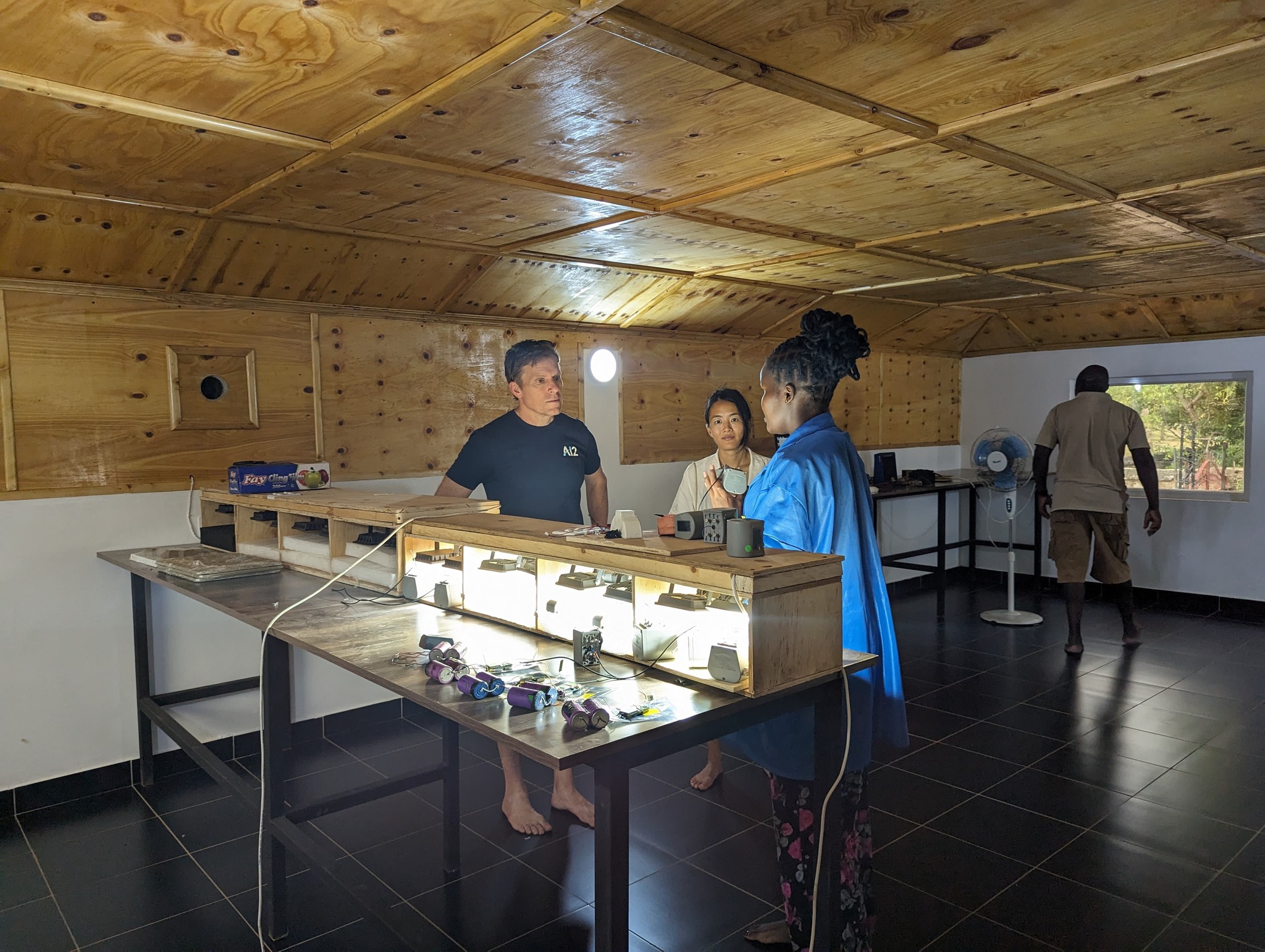 Engineers at an electronics workbench in the workshop